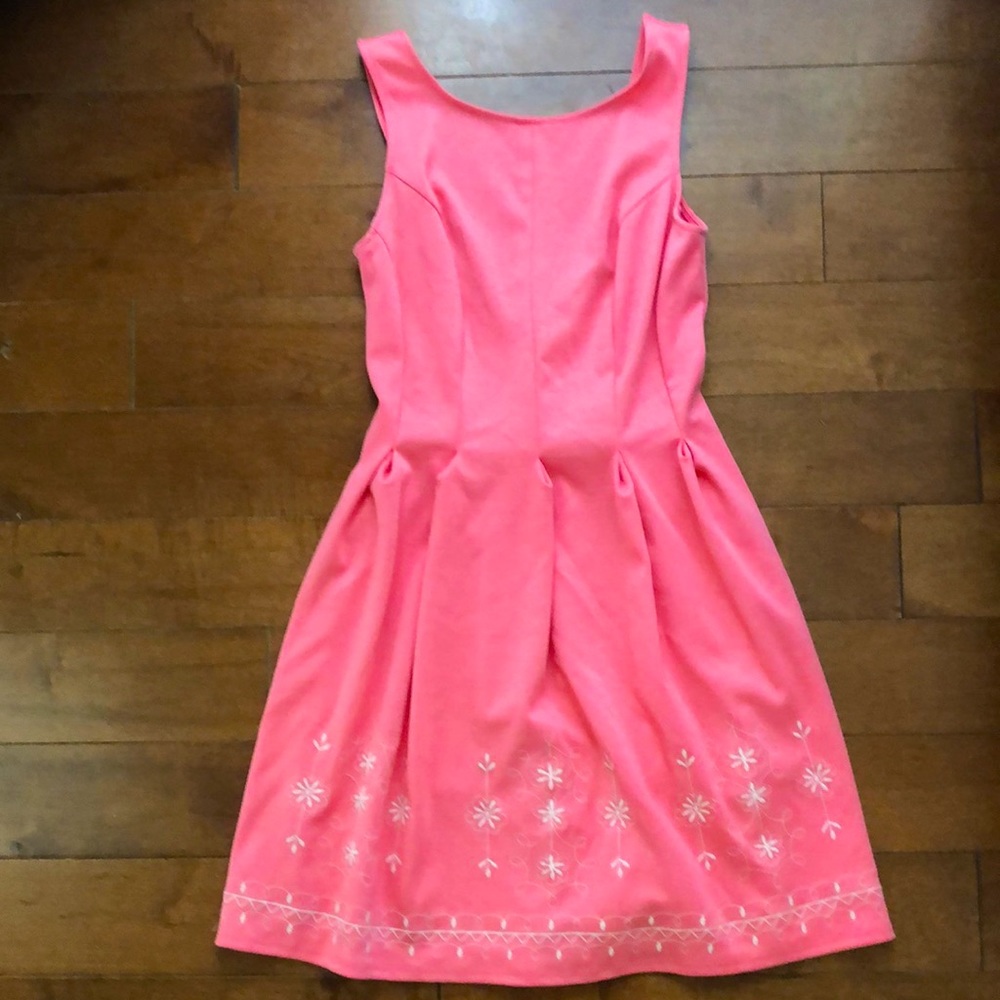 Pink cocktail dress with embroidered white details